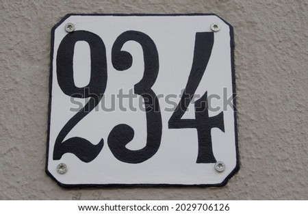 A sign on a wall with the two hundred thirty four -234