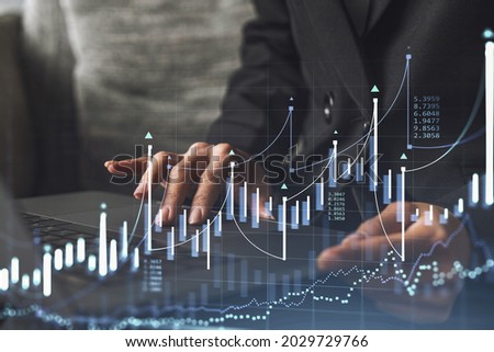Woman typing the keyboard to research stock market to proceed right investment solutions. Internet trading and wealth management concept. Formal wear. Hologram Forex chart over close up shot.
