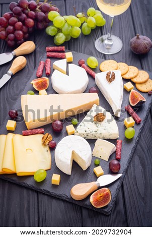 Cheese board with fruits and snack . delicatessen food background