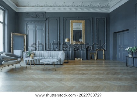 chic interior of the room in the Renaissance style of the 19th century with modern luxury furniture. walls of noble dark color are decorated with stucco and gilded frames, wooden parquet. Royalty-Free Stock Photo #2029733729