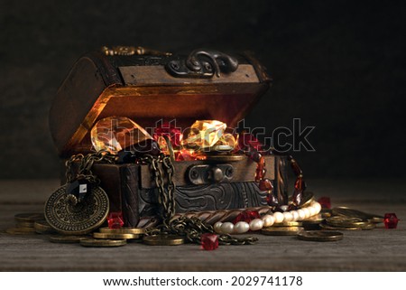 open old wooden chest, many treasures, gems, jewelry and money, pirate treasure, large inheritance, diamonds and rubies