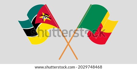 Crossed and waving flags of Mozambique and Benin