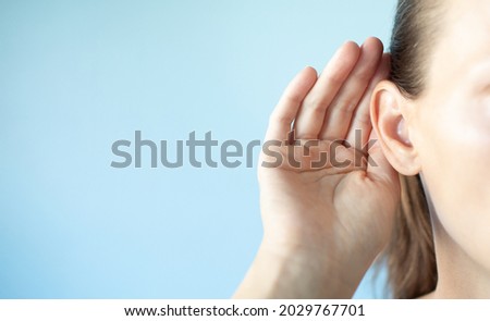Girl listening with hand on ear,  hearing problem closeup Royalty-Free Stock Photo #2029767701