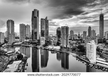 Cloudy black-whtie cityscape of high-rise towers in Surfers paradise city of Australian Gold Coast - aerial view to Pacific ocean from Nerang river. Royalty-Free Stock Photo #2029770077