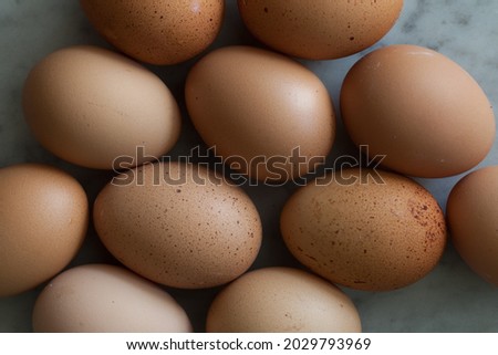 Organic eggs in soft moody light placed on marble background, shown the texture of the surface. Group shot and Close up