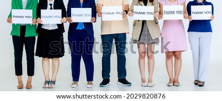 Studio shot of variety fonts thank you letters paper sign holding by unidentified unrecognizable faceless officer staff in business wears stand show appreciation to customers on white background.