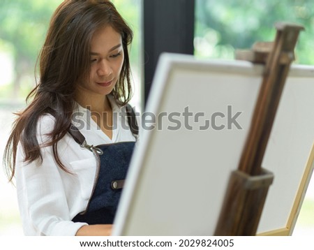 Closeup, Confident female painter painting on canvas, create masterpiece, focus and inspire