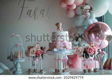 A delicious cake with candies and birthday decorations on the table