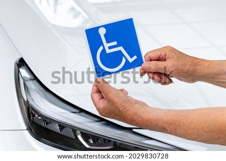 Scene of putting a wheelchair mark on a car