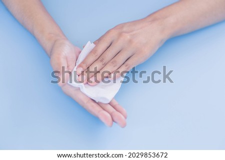 Woman wiping sweat on her hands. Woman suffers from Hyperhidrosis on hand. Royalty-Free Stock Photo #2029853672