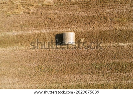 straw roll on dry field texture aerial view summer time