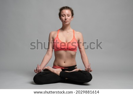 A white Caucasian woman doing an athletic pose for a picture