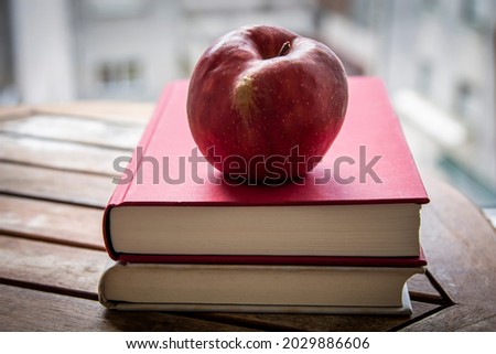 books and apple on the table, back to school concept