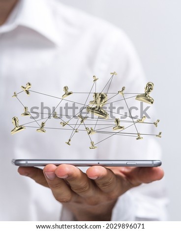 A vertical shot of a businessman holding a phone with a connected network of profile icons