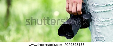 Banner of Man photographer with a photo camera in hand outdoor, World photographer day, creative hobby, copy space, place for text, Photography Concepts Professional.