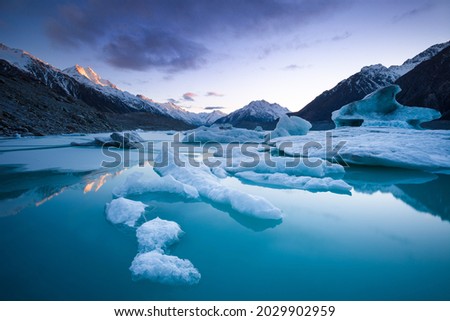 Icebergs in Tasman Lake below Aoraki Mount Cook and Tasman Glacier Royalty-Free Stock Photo #2029902959