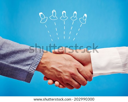 Networking - Two business hand shaking hands, as a sign for success, partnership or support, on a blue background.
