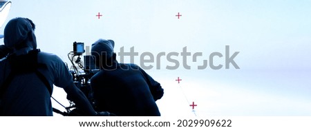 Video production behind the scenes. Making of TV commercial movie that film crew team lightman and cameraman working together with film director in studio. film production concept. Silhouette style. Royalty-Free Stock Photo #2029909622