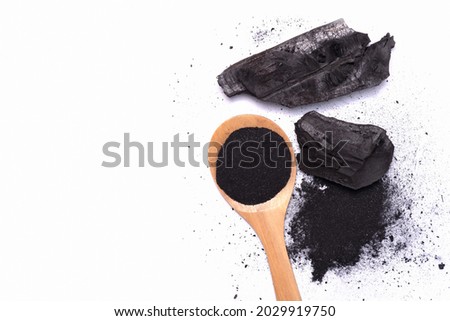 charcoal and charcoal powder on wooden spoon. Skin care,Health care,body wash gel beauty concept.Isolate on White background with clipping mask path. Above top view.