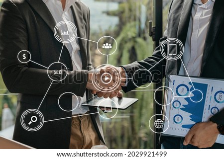 Business partnership meeting concept. Image businessmans handshake. Successful businessmen handshaking after good deal. with VR icon

