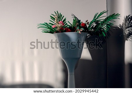 deep shadows on from a white vase on a white fabric background. contrast and shadows