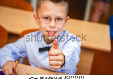 Happy child at school desk at school after school