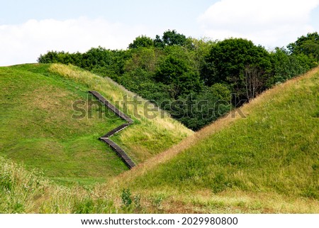 Hilly country. Walking paths up the mountain. Kernavė, site of the ancient city. High hills by the river. Wooden staircase to the mountain. The famous Lithuanian landscape.