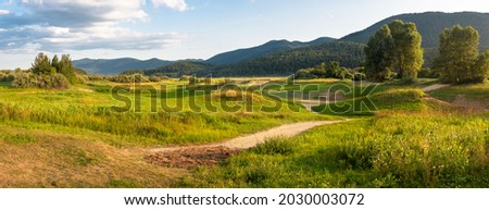 The canyon of a drained lake Cerknica. Lake Cerknica is one of the largest intermittent lakes in Europe. All water flows into the esophagus at Cerknica field.  Javorniki hill in the background. Royalty-Free Stock Photo #2030003072
