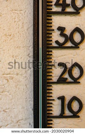 A vertical shot of a height measurement ruler on the wall