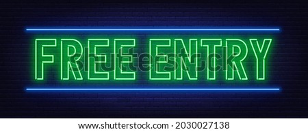 Neon sign free entry on brick wall background.