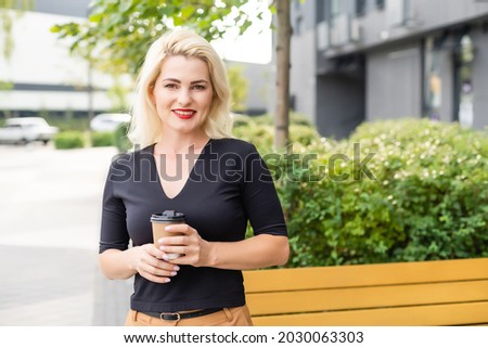 Beautiful Woman Going To Work With Coffee Walking Near Office Building. Portrait Of Successful Business Woman Holding Cup Of Hot Drink In Hand On Her Way To Work On City Street.