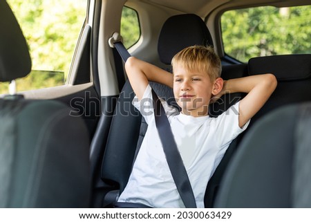 Little blond kid boy in the car