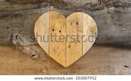 Love Valentines wooden heart from recycled old palette on old grey Elm background, copy space