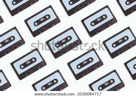 Cassette tapes pattern on a blue pastel background. Creative layout concept.