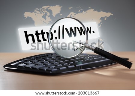 Magnifying glass on computer keyboard with web page address and cursor arrow, internet search,  marketing and global communications concept Royalty-Free Stock Photo #203013667