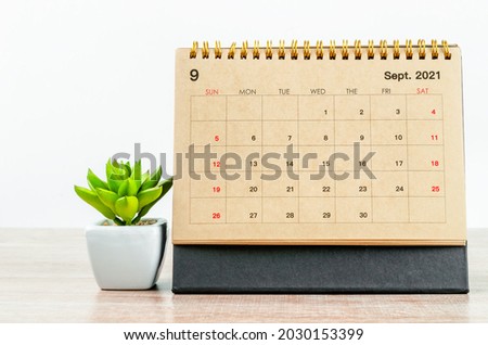 September 2021 Desk calendar with cactus tree on wooden table. Royalty-Free Stock Photo #2030153399