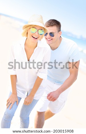 A picture of a joyful couple having fun at the beach
