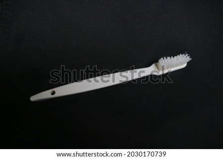 used toothbrush for cleaning teeth on isolated background photo