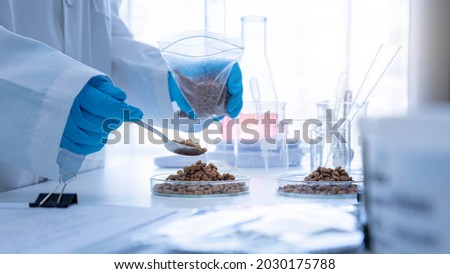 Close up picture of quality control personnel are inspecting the quality of canned pet food. Physical quality inspection. Quality control process of pet food industry.