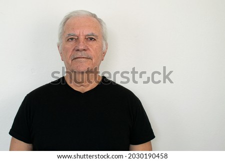 old man male senior  black shirt closeup wall healthy white background smile happy face expression friendly looking mature retired