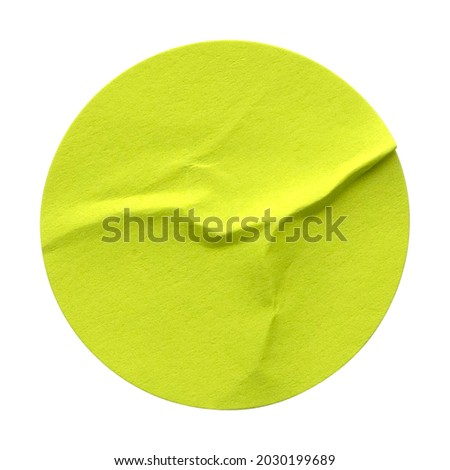Green circle paper sticker label isolated on white background.
