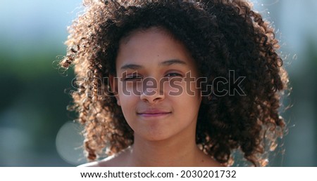 Beautiful preteen girl child portrait smiling outside, black African descent Royalty-Free Stock Photo #2030201732