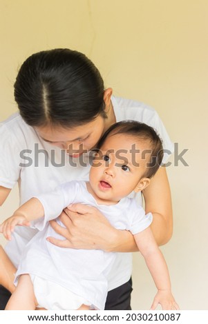 Happy asian mother and baby girl, mother happying playing with her daughter, happy baby girl play with her mom