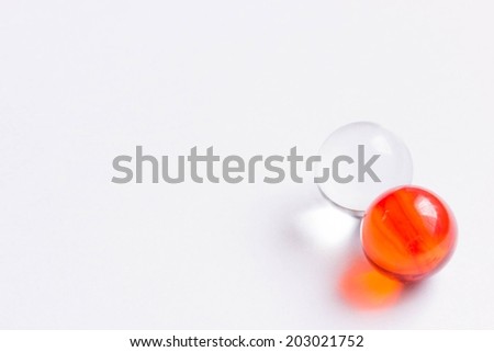 Two red and clear glass marbles - Lower right