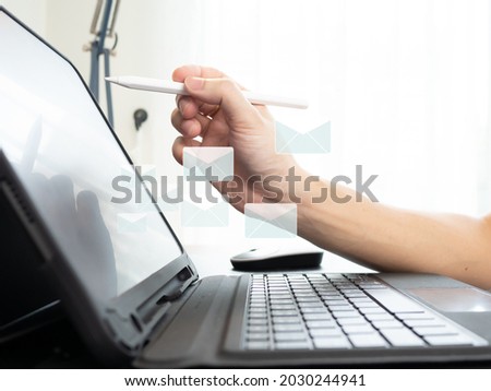 men hand using pen with tablet sending e-mail.work from home concept.