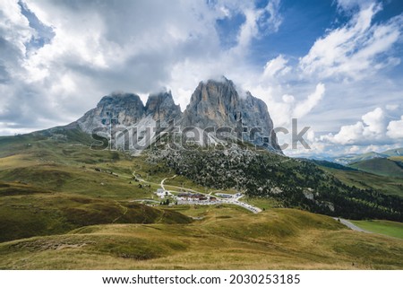 Aerial view of Passo Sella - Sellajoch and mountain Sassolungo - Langkofel in cloudscape, Alpe di Siusi, Dolomiti mountain - South Tyrol, Italy, Europe Royalty-Free Stock Photo #2030253185