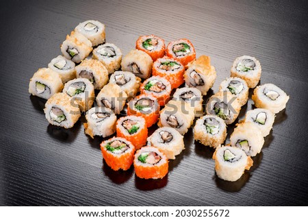 Sushi set isolated on black background. Photo for the menu and site. Top view