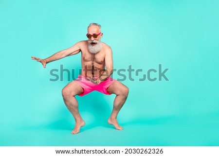Photo of excited healthy old man dance enjoy seaside voyage wear sunglass shorts isolated teal color background