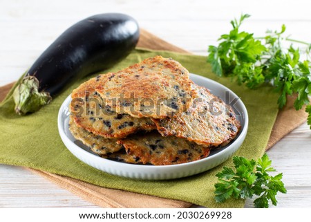 Fried eggplant burgers on a wooden board. Home quick eggplant recipe. Vegetarian burgers closeup Royalty-Free Stock Photo #2030269928