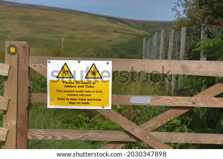 A sign warning of the danger posed by adders and ticks in the Northumberland countryside